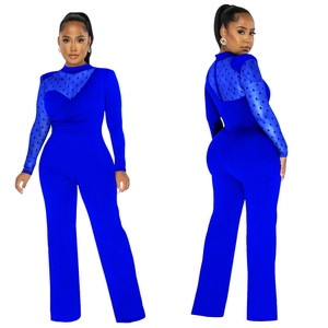 Detail view of royal blue jumpsuit with polka dot mesh sleeves and wide-leg trousers