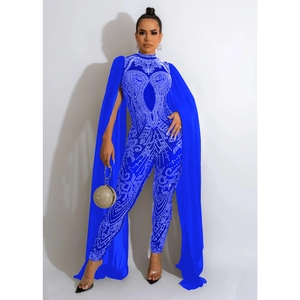 Detail of royal blue rhinestone jumpsuit with sheer mesh cape and sparkly accents