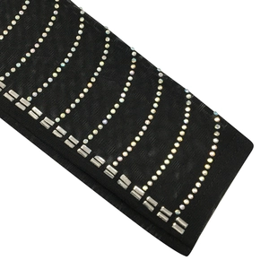 Detailed macro view of black mesh fabric adorned with colorful rhinestones and crystal gems