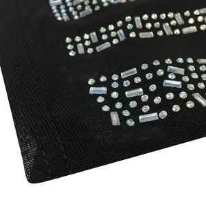 Macro detail of black mesh fabric with rainbow rhinestones on sexy club dress