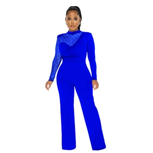 Detail of bright blue jumpsuit featuring sheer polka dot mesh sleeves and high waist cut