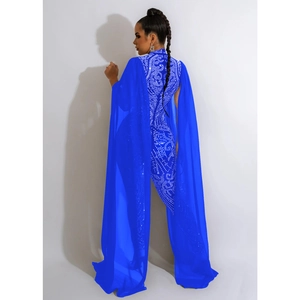 Detail of blue jumpsuit featuring rhinestone pattern on the back with a mesh chiffon cape