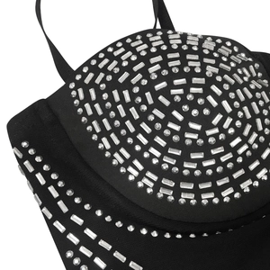 Detail of black corset dress featuring rhinestone patterns and fine shoulder straps