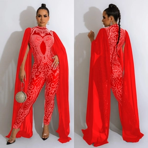 Women's red jumpsuit set with sparkling rhinestones and a sheer mesh long cape