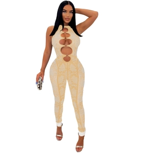 Detail of mesh jumpsuit with rhinestone patterns and golden ring hollow-out design
