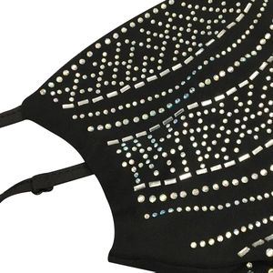 Macro detail of sexy black mesh dress showing glittering rhinestones and adjustable straps