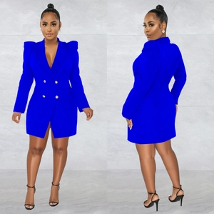 Detail of royal blue blazer dress featuring dramatic puff sleeves and gold buttons