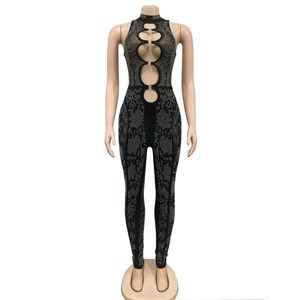 Detail of black mesh jumpsuit featuring silver rhinestones and metal ring cutouts
