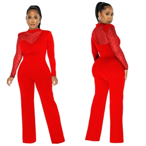 Detail of red jumpsuit showing sheer polka dot mesh sleeves and high neck design