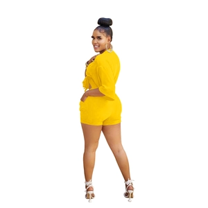 Detailed view of women's bright yellow two-piece set with short sleeve top and high waist shorts