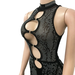 Detail of mesh jumpsuit featuring sparkling rhinestones and metal ring cut-outs