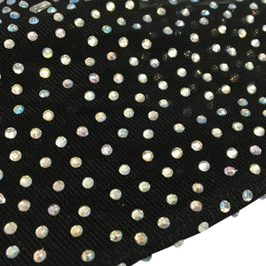 Macro detail of sexy black sheer mesh fabric with colorful sparkling AB rhinestones