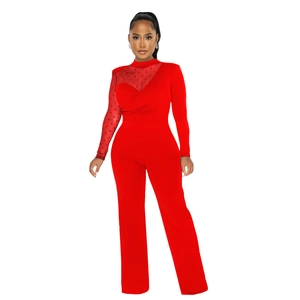 Detail of red mesh patchwork with polka dot texture on long-sleeved jumpsuit