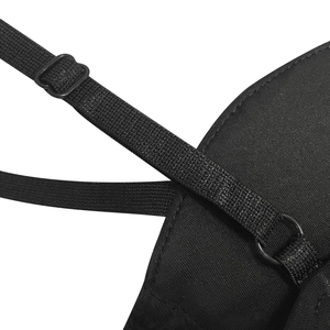 Detail view of the adjustable black shoulder straps with sturdy plastic buckles on the dress