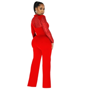 Close-up of red mesh sheer long sleeves with 3D polka dots on a fashion jumpsuit