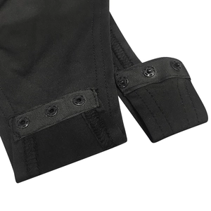 Detail view of the black bodysuit bottom featuring three secure snap buttons and reinforced stitching