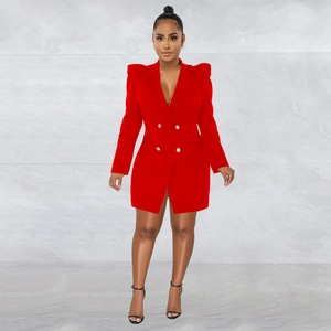 Detail of red blazer dress featuring padded shoulders and decorative gold buttons