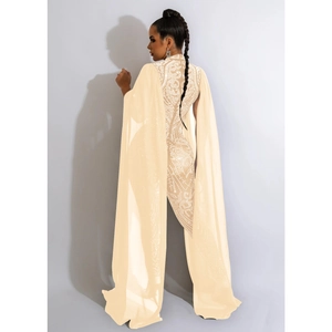 Close-up of champagne rhinestone jumpsuit with elegant sheer mesh cape and damask patterns