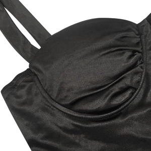 Close-up of black satin bustier dress featuring ruched cups and delicate spaghetti straps