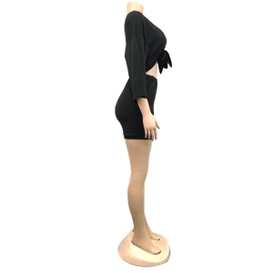 Side view of black long sleeve tie-front crop top and bodycon skirt set on mannequin