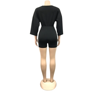 Back view of a black slim fit romper with mid-length sleeves on a mannequin stand