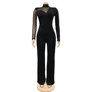Detail of sheer polka dot mesh sleeve and slim fit design on black jumpsuit
