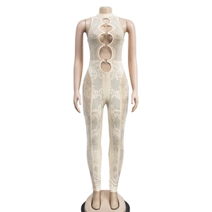 Detail of beige mesh jumpsuit with sparkling rhinestones and metal ring cut-outs