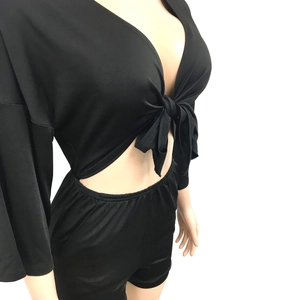 Close-up of black two-piece set featuring a V-neck tie-front top and high waist shorts