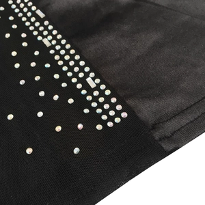 Detail of black mesh fabric with iridescent rhinestones on a sexy bodycon dress