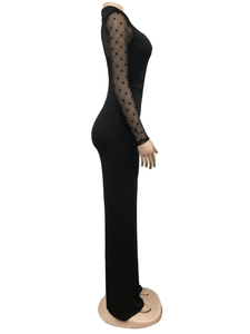 Close-up of sheer mesh sleeves with flocking polka dots on this slim black dress