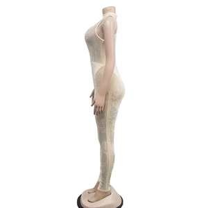 Detailed side view of nude mesh sleeveless jumpsuit with sparkling rhinestone embellishments