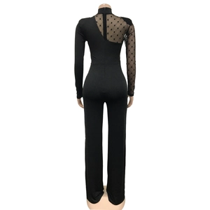 Detailed back view of a black jumpsuit featuring polka dot mesh and hidden zipper closure