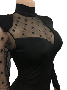 Detail view of black polka dot mesh sleeves and high neck collar on slim bodysuit