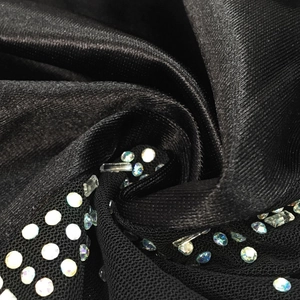 Macro detail of luxury black satin and mesh fabric with sparkling multicolor rhinestones