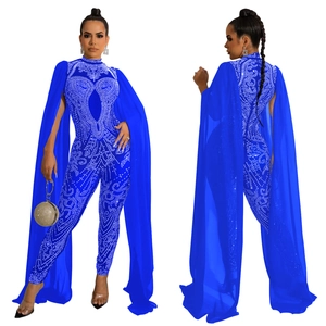 Detail view of royal blue jumpsuit with rhinestones and elegant long mesh cape