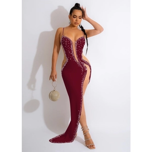 Detail of burgundy maxi dress featuring sparkling rhinestones and sheer mesh cutouts