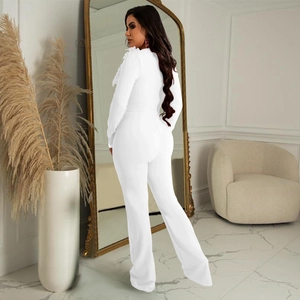 Rear view of white long-sleeved jumpsuit featuring a sleek silhouette and flared leg cut