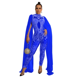Detail of royal blue jumpsuit with silver rhinestones and floor-length cape sleeves
