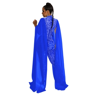 Detail of royal blue jumpsuit with rhinestone spiral patterns and flowing cape