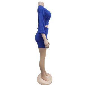 Detail view of electric blue long-sleeve crop top and bodycon skirt set on mannequin