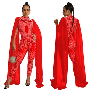 Detailed view of red rhinestone jumpsuit with long sheer mesh cape and heart pattern