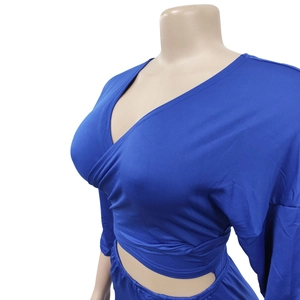 Detail of dark blue wrap-style long sleeve top with V-neckline on a mannequin