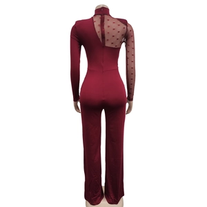 Detail view of burgundy jumpsuit back with sheer polka dot mesh and invisible zipper