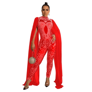 Close-up of red rhinestone catsuit featuring sheer mesh cape sleeves and mock neck