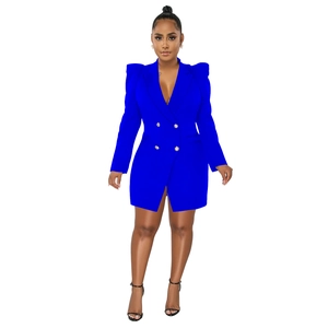 Detail of royal blue blazer dress featuring gold buttons and structured puff sleeves
