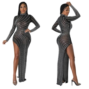 Detailed close-up of rhinestones on long sleeve mesh dress with high side slit