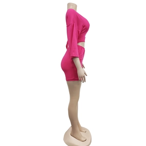 Detail view of pink long sleeve crop top and bodycon skirt set on mannequin