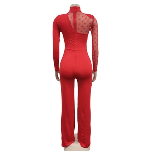Detailed back view of a red jumpsuit featuring polka dot mesh sleeve and back zipper