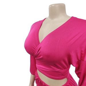 Detail of fuchsia wrap top featuring a deep V-neck and stylish waist tie design