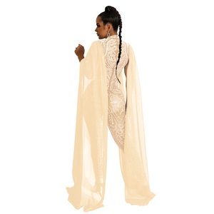 Detail view of the intricate rhinestone patterns and mesh cape on this beige jumpsuit